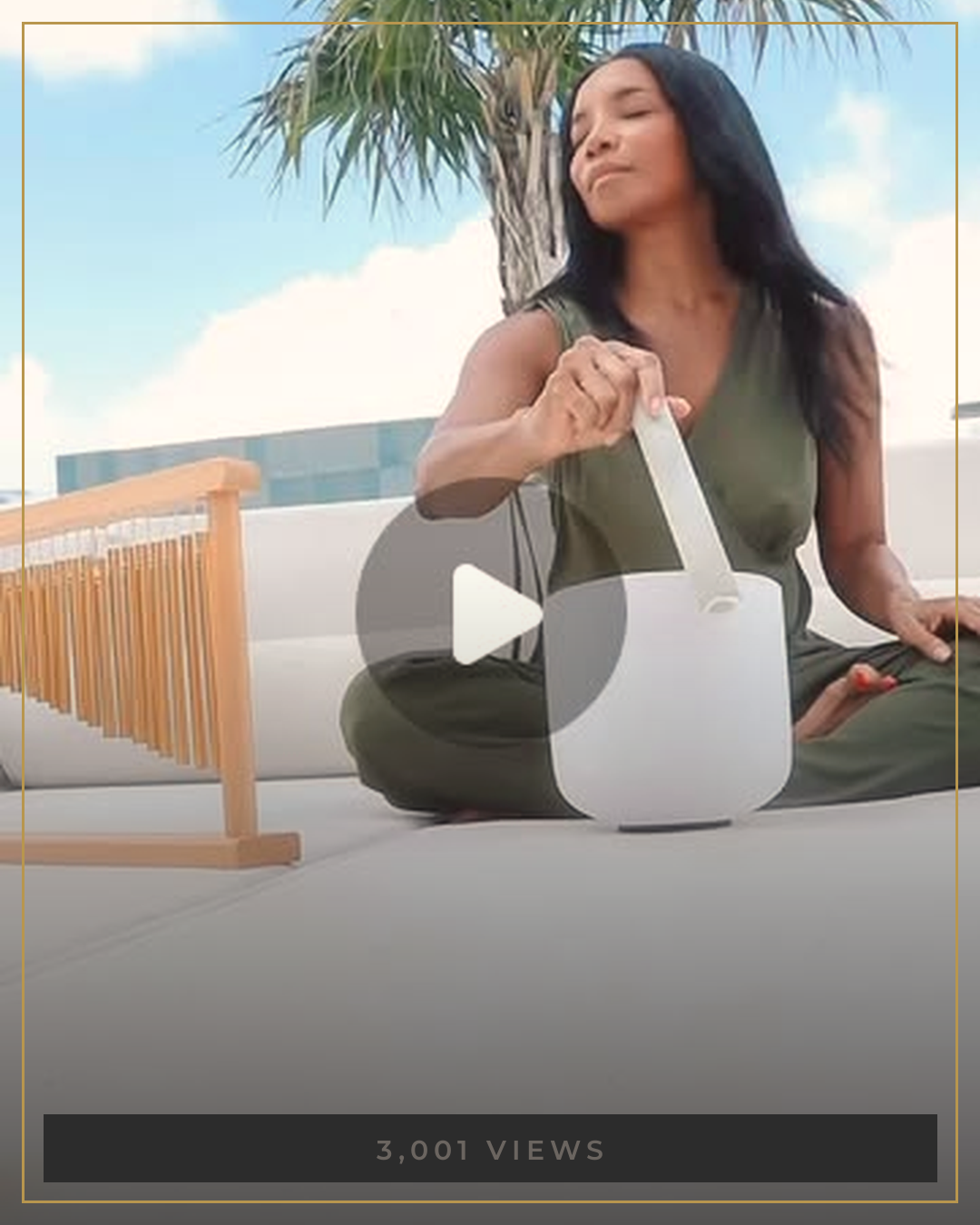 AUTHOR playing a singing bowl on a rooftop under palm trees
